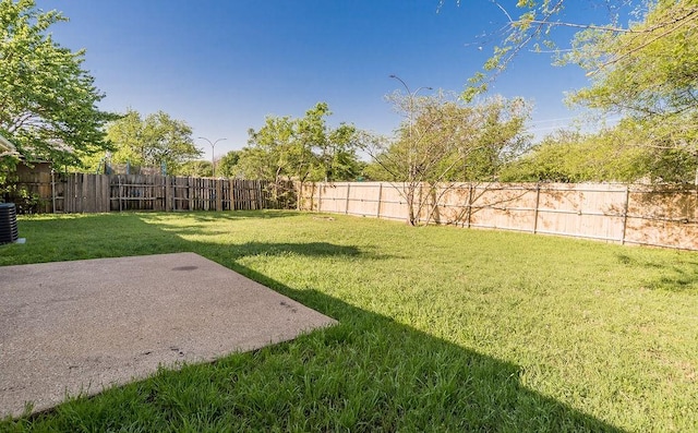 view of yard featuring a patio area, central air condition unit, and a fenced backyard