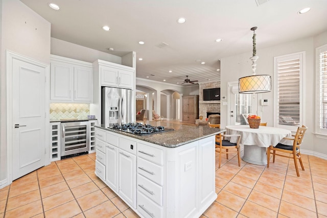 1406 Jacob Ave, Keller, TX 76248 - kitchen with black gas stovetop, wine cooler, stainless steel fridge with ice dispenser, and recessed lighting