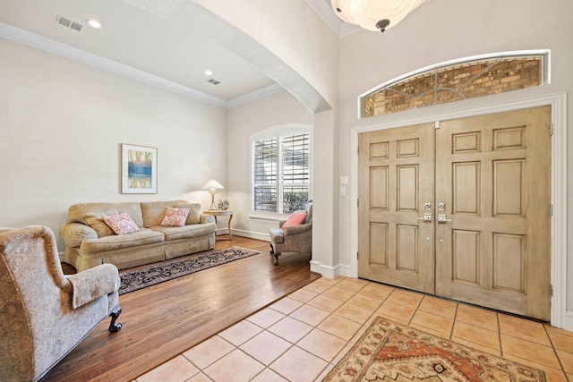 1406 Jacob Ave, Keller, TX 76248 - foyer entrance featuring visible vents, baseboards, arched walkways, crown molding, and light tile patterned flooring
