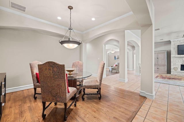 1406 Jacob Ave, Keller, TX 76248 - dining area with light tile patterned floors, arched walkways, ornamental molding, visible vents, and baseboards