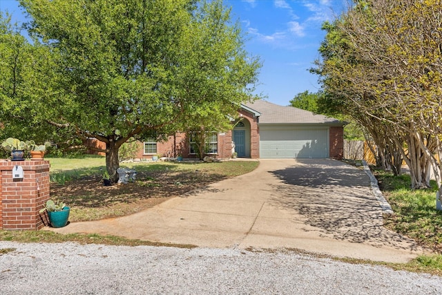821 Wandering Ct, Granbury, TX 76049 - view of front facade featuring concrete driveway, brick siding, and an attached garage
