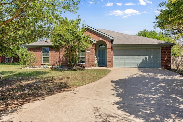821 Wandering Ct, Granbury, TX 76049 - view of front of home with driveway, an attached garage, brick siding, and a front lawn