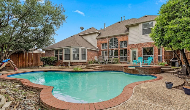 1870 Hillcroft Dr, Rockwall, TX 75087 - view of swimming pool with a patio area, grilling area, a pool with connected hot tub, and a fenced backyard