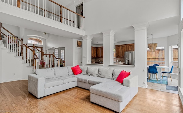 1870 Hillcroft Dr, Rockwall, TX 75087 - living room with light wood-style floors, ornate columns, and stairs