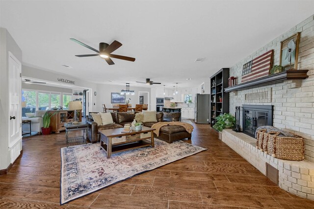 1346 Kiowa Dr E, Lake Kiowa, TX 76240 - living area with dark wood-type flooring, a brick fireplace, and a ceiling fan