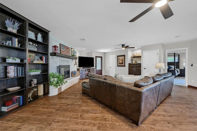 1346 Kiowa Dr E, Lake Kiowa, TX 76240 - living room with a fireplace, wood finished floors, and ceiling fan