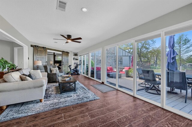 1346 Kiowa Dr E, Lake Kiowa, TX 76240 - sunroom featuring wood finished floors, visible vents, and a barn door