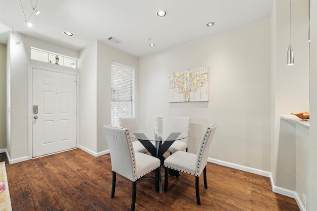 dining space featuring baseboards, wood finished floors, visible vents, and recessed lighting