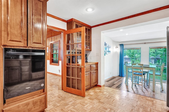 kitchen featuring crown molding, oven, baseboards, and recessed lighting