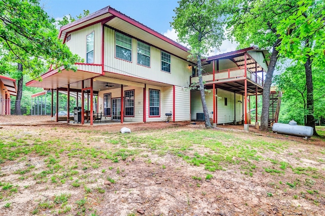 rear view of property with a ceiling fan, a patio, fence, and stairs