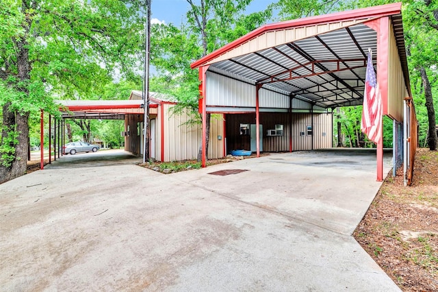 view of parking featuring a detached carport and concrete driveway