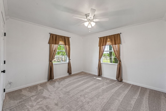 spare room featuring plenty of natural light, crown molding, and a ceiling fan