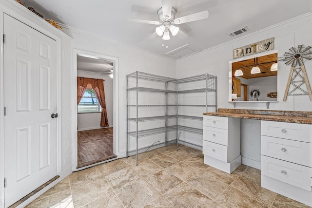 bathroom featuring a ceiling fan, baseboards, ornamental molding, and visible vents