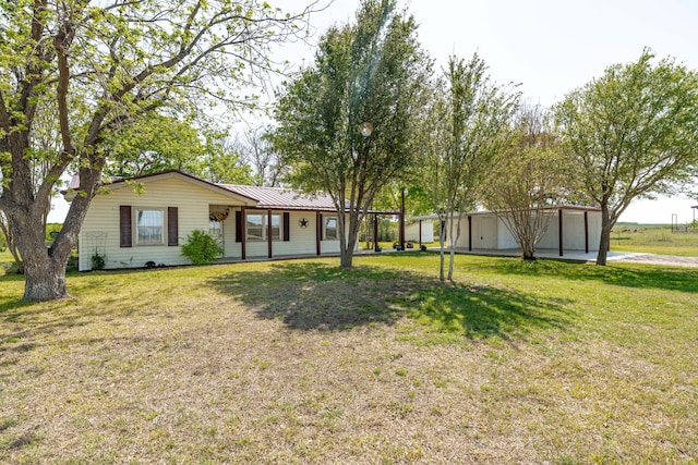 ranch-style home with a front lawn and metal roof