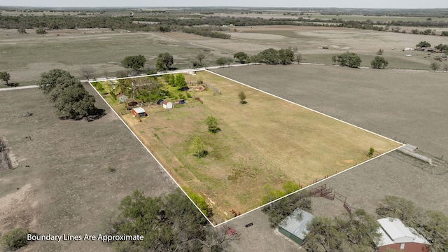 birds eye view of property with a rural view