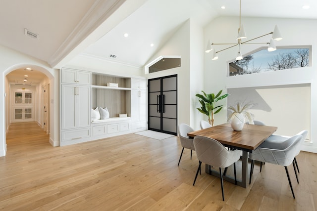 4147 Deep Valley Dr, Dallas, TX 75244 - dining room featuring light wood-style floors, arched walkways, high vaulted ceiling, and a notable chandelier