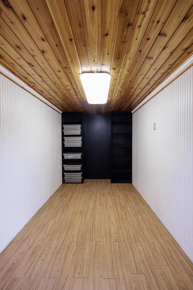 unfurnished room with wood ceiling and wood finished floors