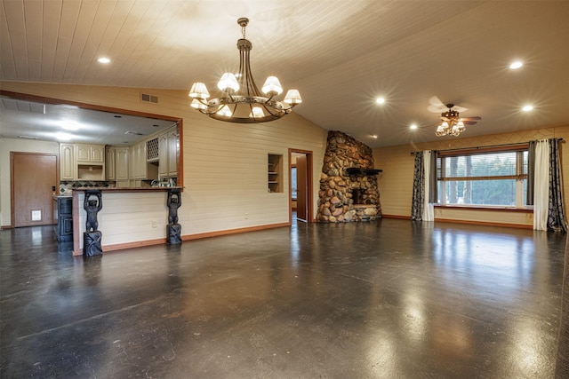 unfurnished living room featuring lofted ceiling, visible vents, wood walls, and ceiling fan with notable chandelier