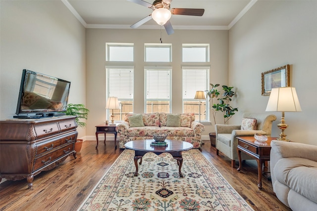 781 Bosley Dr, Fate, TX 75087 - living room featuring a ceiling fan, ornamental molding, wood finished floors, and baseboards