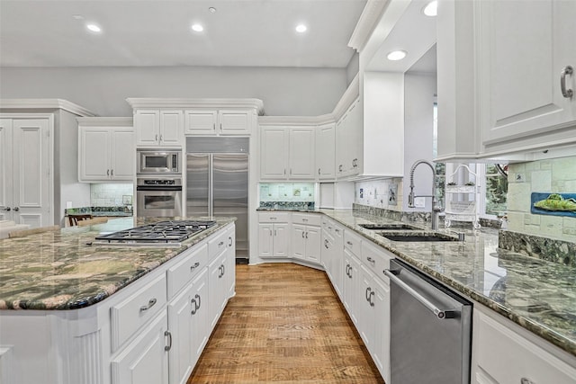 10040 Little Horn Cir, Frisco, TX 75035 - kitchen featuring built in appliances, recessed lighting, white cabinets, decorative backsplash, and dark stone counters