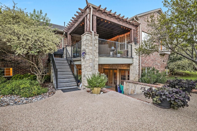 10040 Little Horn Cir, Frisco, TX 75035 - view of front of house with stairway, a balcony, and french doors