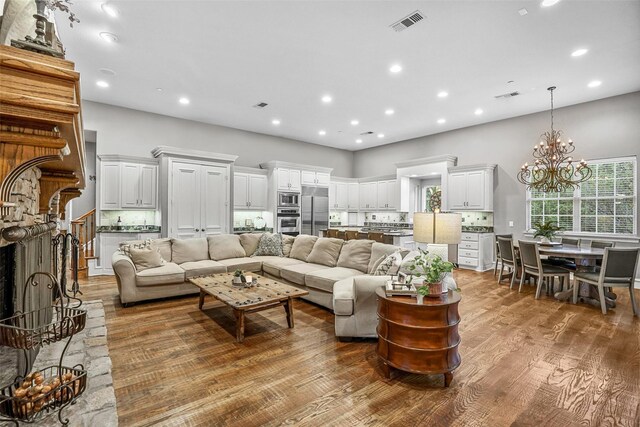 10040 Little Horn Cir, Frisco, TX 75035 - living room with a chandelier, recessed lighting, and wood finished floors