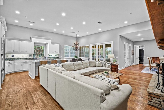 10040 Little Horn Cir, Frisco, TX 75035 - living room with light wood-style floors, recessed lighting, and a chandelier