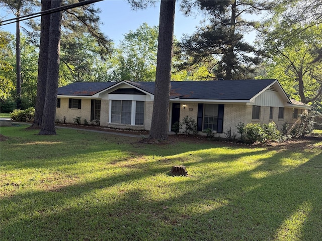 single story home with brick siding and a front lawn