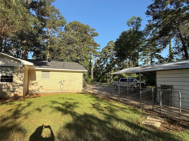 view of yard with a carport and fence