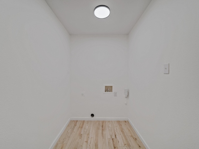 laundry room with electric dryer hookup, baseboards, washer hookup, laundry area, and light wood finished floors