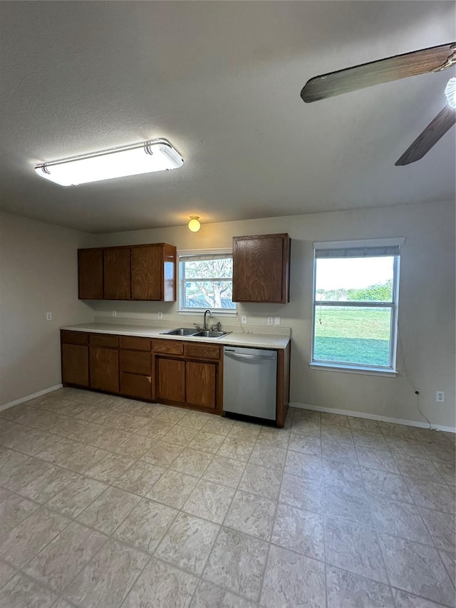 510 Green Acres Rd, Weatherford, TX 76088 - kitchen with a sink, light countertops, stainless steel dishwasher, and baseboards