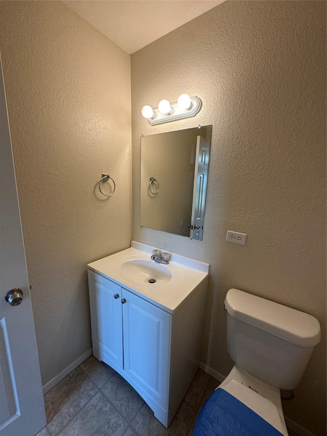 510 Green Acres Rd, Weatherford, TX 76088 - bathroom featuring a textured wall, vanity, baseboards, and toilet