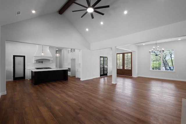 109 Post Oak Cv, Sunset, TX 76270 - unfurnished living room featuring ceiling fan with notable chandelier, high vaulted ceiling, beam ceiling, and dark wood-style flooring