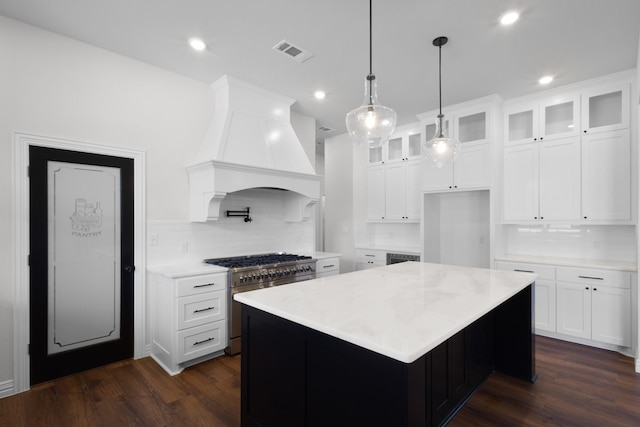 109 Post Oak Cv, Sunset, TX 76270 - kitchen featuring custom exhaust hood, backsplash, stainless steel range, and visible vents