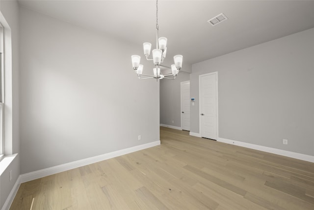 1616 Olympia Ave, Corinth, TX 76208 - spare room featuring a chandelier, baseboards, and light wood-style floors
