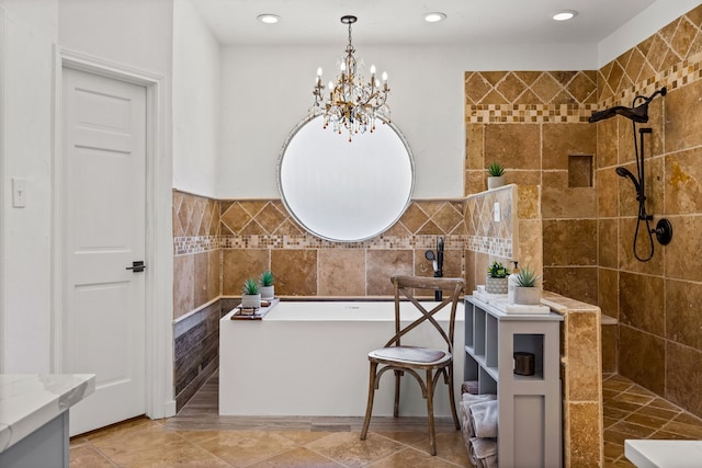 bathroom with a chandelier, recessed lighting, a walk in shower, a freestanding bath, and tile walls