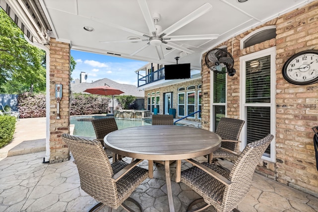 view of patio / terrace featuring outdoor dining area and a ceiling fan