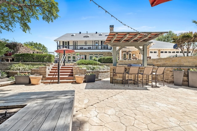 view of patio with a pergola and outdoor dry bar