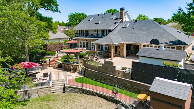 back of house featuring stairway, a patio, a balcony, and a fenced backyard