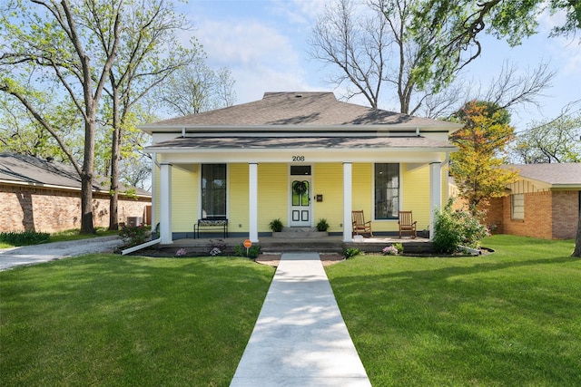 208 Corsicana St, Hillsboro, TX 76645 - view of front facade with covered porch, a front yard, and roof with shingles