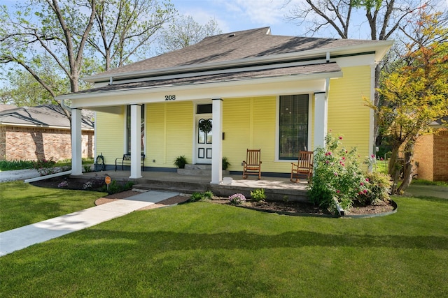 208 Corsicana St, Hillsboro, TX 76645 - view of front of property with covered porch, a shingled roof, and a front lawn