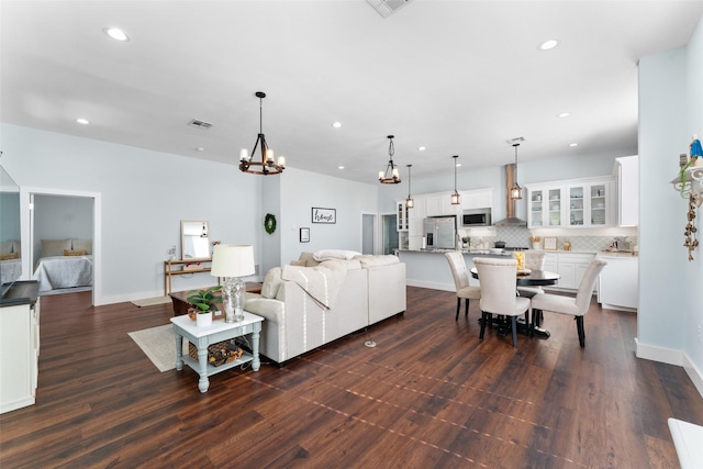 208 Corsicana St, Hillsboro, TX 76645 - living room with recessed lighting, a chandelier, dark wood-style floors, and baseboards