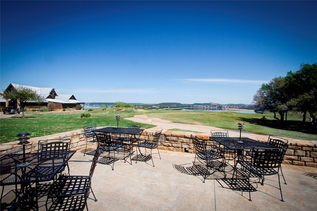 view of patio / terrace featuring outdoor dining area and a water view