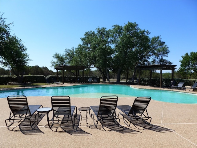 community pool featuring a pergola and a patio area