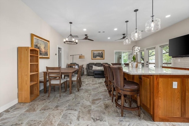 kitchen featuring visible vents, open floor plan, light countertops, brown cabinetry, and recessed lighting