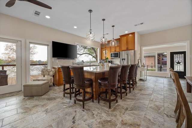 dining space featuring visible vents, ceiling fan, stone tile flooring, and recessed lighting