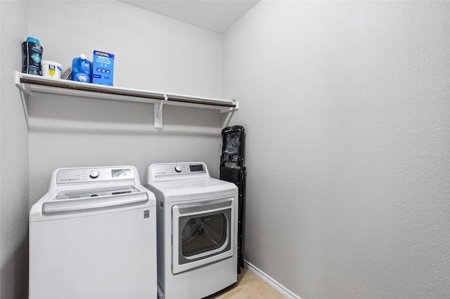 8312 White Hart Dr, Fort Worth, TX 76179 - laundry area featuring laundry area, separate washer and dryer, light tile patterned flooring, and baseboards