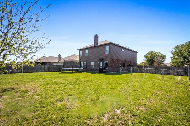 8312 White Hart Dr, Fort Worth, TX 76179 - view of yard with a fenced backyard and a trampoline
