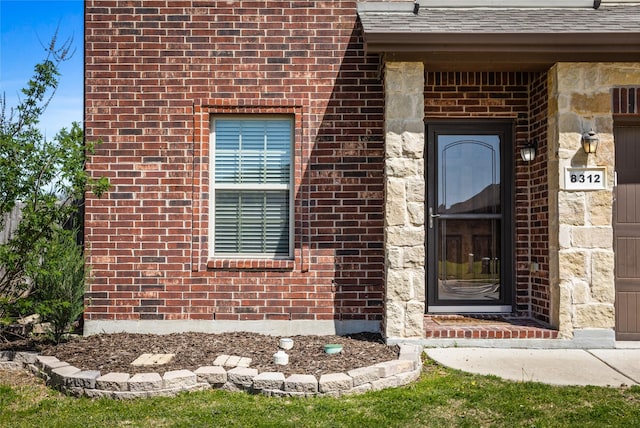 8312 White Hart Dr, Fort Worth, TX 76179 - property entrance with roof with shingles and brick siding