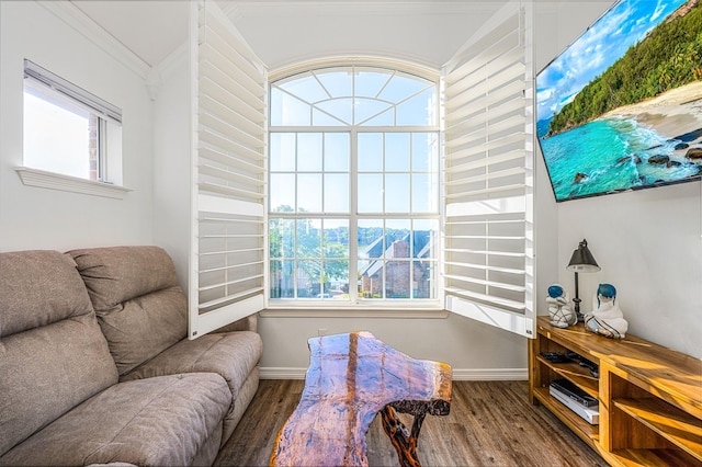 interior space featuring baseboards, ornamental molding, and wood finished floors